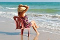 Beautiful girl on a chair on the coast Royalty Free Stock Photo