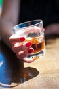 The girl is sitting in a cafe and is holding a glass of whiskey Royalty Free Stock Photo