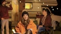 Girl sitting on a camping chair in a cold night of autumn Royalty Free Stock Photo