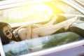 Girl sitting in car during day, photo toned