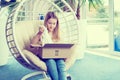 Girl sitting in chair and opening a package