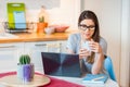 Girl sitting confortable at home using modern technology