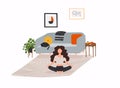 Girl sitting cross-legged in her room or apartment, practicing yoga and enjoying meditation Royalty Free Stock Photo