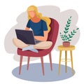 The girl is sitting cross-legged in a red chair and working on a laptop, next to it is a small table and an indoor plant Royalty Free Stock Photo