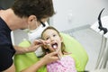 Girl sitting on dental chair on her regular dental checkup