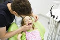 Girl sitting on dental chair on her regular dental checkup Royalty Free Stock Photo