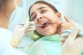 Girl sitting at dental chair with open mouth during oral check up while doctor. Visiting dentist office. Dentistry Royalty Free Stock Photo