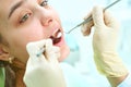 Girl sitting at dental chair with open mouth during oral check up while doctor. Visiting dentist office. Dentistry Royalty Free Stock Photo