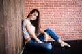 Girl sitting down against wooden Royalty Free Stock Photo