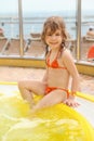 Girl sitting on edge of swimming pool Royalty Free Stock Photo