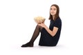 Girl sitting on the floor with a bowl of popcorn. Isolated on white Royalty Free Stock Photo