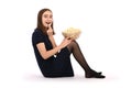 Girl sitting on the floor with a bowl of popcorn. Isolated on white Royalty Free Stock Photo