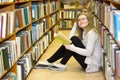 Girl sitting on floor in the old library