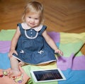 Girl sitting in the floor with tablet computer