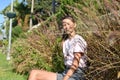 Girl sitting in flowers in summer. beautiful teenage girl posing in grass