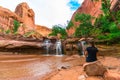 Girl sitting in front of Waterfall