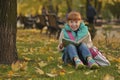 Girl sitting on grass book with a book, funny expression on his face Royalty Free Stock Photo