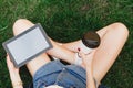 Girl sitting on the grass with cup of coffee Royalty Free Stock Photo