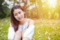 A girl sitting on the grass and labtop near her. A glasses is on the labtop. Royalty Free Stock Photo