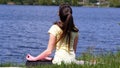 Girl sitting on the grass and meditate