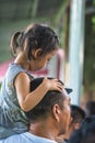 Girl sitting on her father shoulder