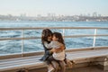 girl sitting with her sister on a ferryboat