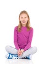 Girl sitting with legs crossed Royalty Free Stock Photo