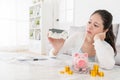 Girl sitting in living room looking at house model Royalty Free Stock Photo