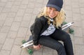 Girl sitting on longboard