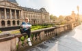Girl sitting with a map on the background of the Royal Palace in Brussels, Belgium