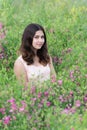 Girl sitting on meadow with flowers Royalty Free Stock Photo