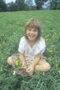 A girl sitting in a meadow of yellow flowers,Homestead, PA