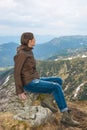 Girl is sitting on a mountain top Royalty Free Stock Photo