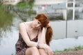 Girl sitting near lake Royalty Free Stock Photo