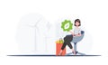 The girl is sitting next to a package with healthy food and holding an EKO icon. Healthy food, ecology, recycling and Royalty Free Stock Photo