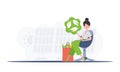 The girl is sitting next to a package with healthy food and holding an EKO icon. Healthy food, ecology, recycling and Royalty Free Stock Photo