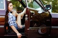 Girl sitting in open car, photo toned