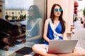 Girl sitting outdoor with coffee in sunglasses. Royalty Free Stock Photo