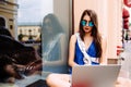 Girl sitting outdoor with coffee in sunglasses. Royalty Free Stock Photo