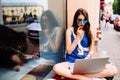 Girl sitting outdoor with coffee in sunglasses. Royalty Free Stock Photo