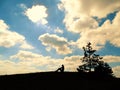 Girl sitting over the mountain`s silhouette