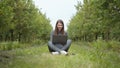 Girl sitting in park or forest, opening laptop on nature. IT specialist working at self isolation outdoors. Women