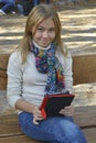 Girl sitting in the park and read e-books