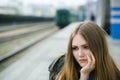 Girl sitting at the railway station