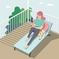 Girl sitting, reading alone with sleeping cat on balcony