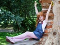 Girl sitting on the red brick wal Royalty Free Stock Photo