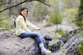 Girl sitting on rock cliff edge Royalty Free Stock Photo