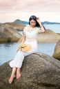 Girl sitting on the seaside rocks Royalty Free Stock Photo