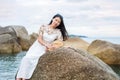 Girl sitting on the seaside rocks Royalty Free Stock Photo