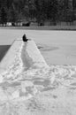 Girl sitting on a snowy footbridge on a frozen lake Jasna, Kranjska Gora, Slovenia